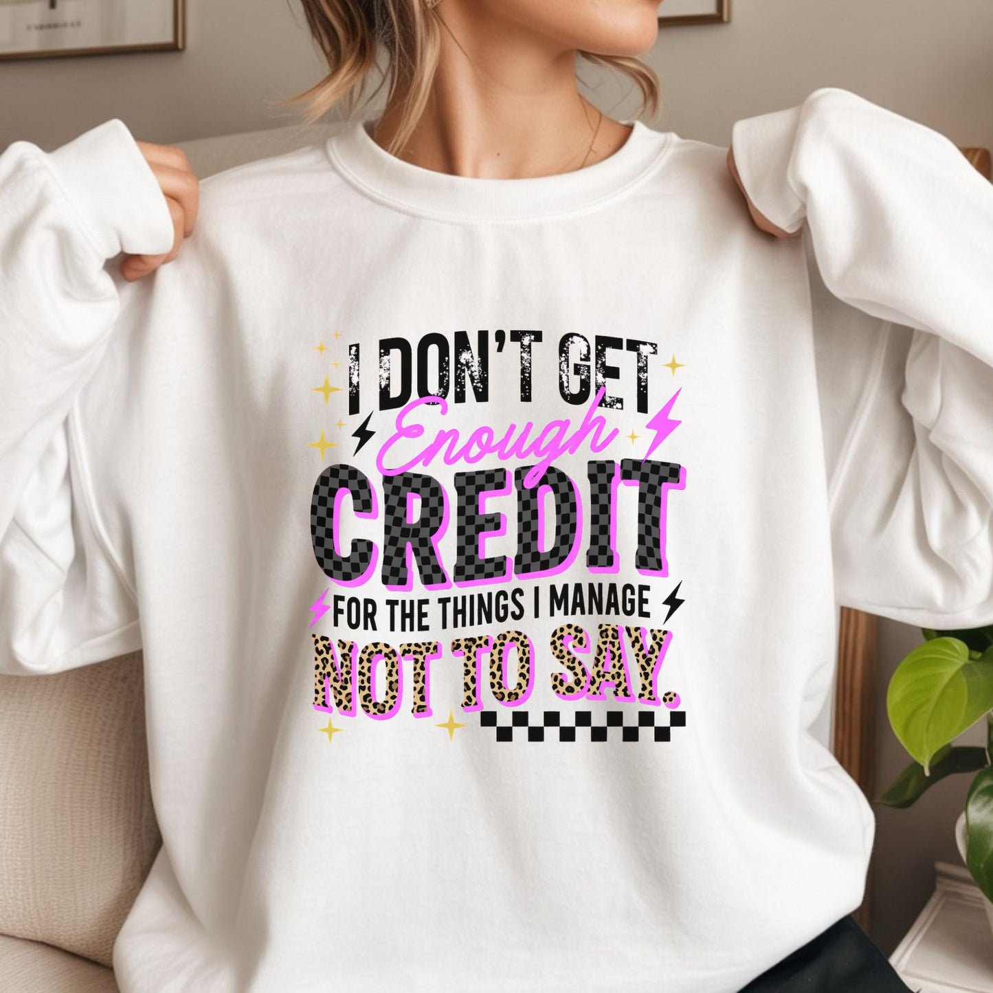 Funny sarcastic quote design featuring I Don't Get Enough Credit For The Things I Manage Not To Say with checkered accents and leopard print details, perfect for witty women and humor lovers