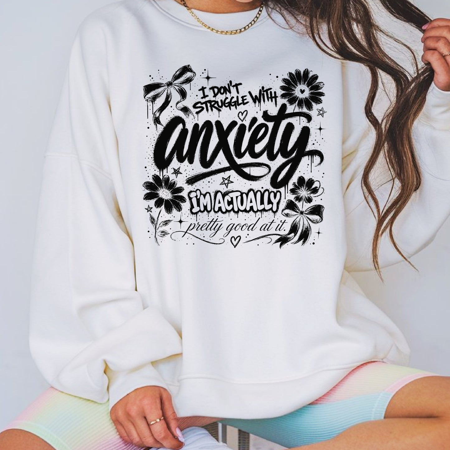 Black and white anxiety humor graphic featuring floral doodles, bows, stars, and the phrase I Don't Struggle With Anxiety I'm Actually Pretty Good At It in a trendy hand-lettered design