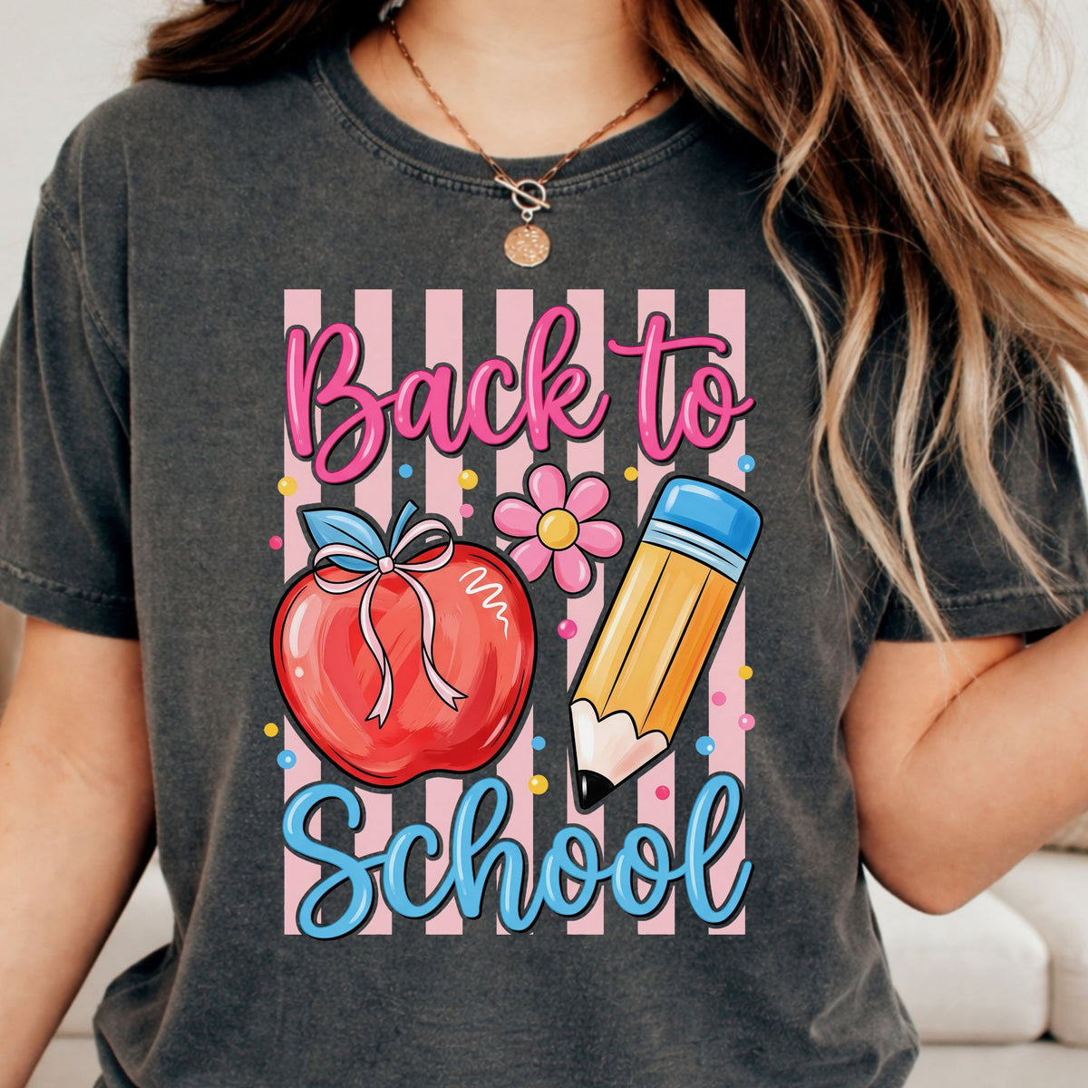 Back to School DTF transfer featuring a red apple with a bow, yellow pencil, pink vertical stripes, flower, and colorful confetti accents.