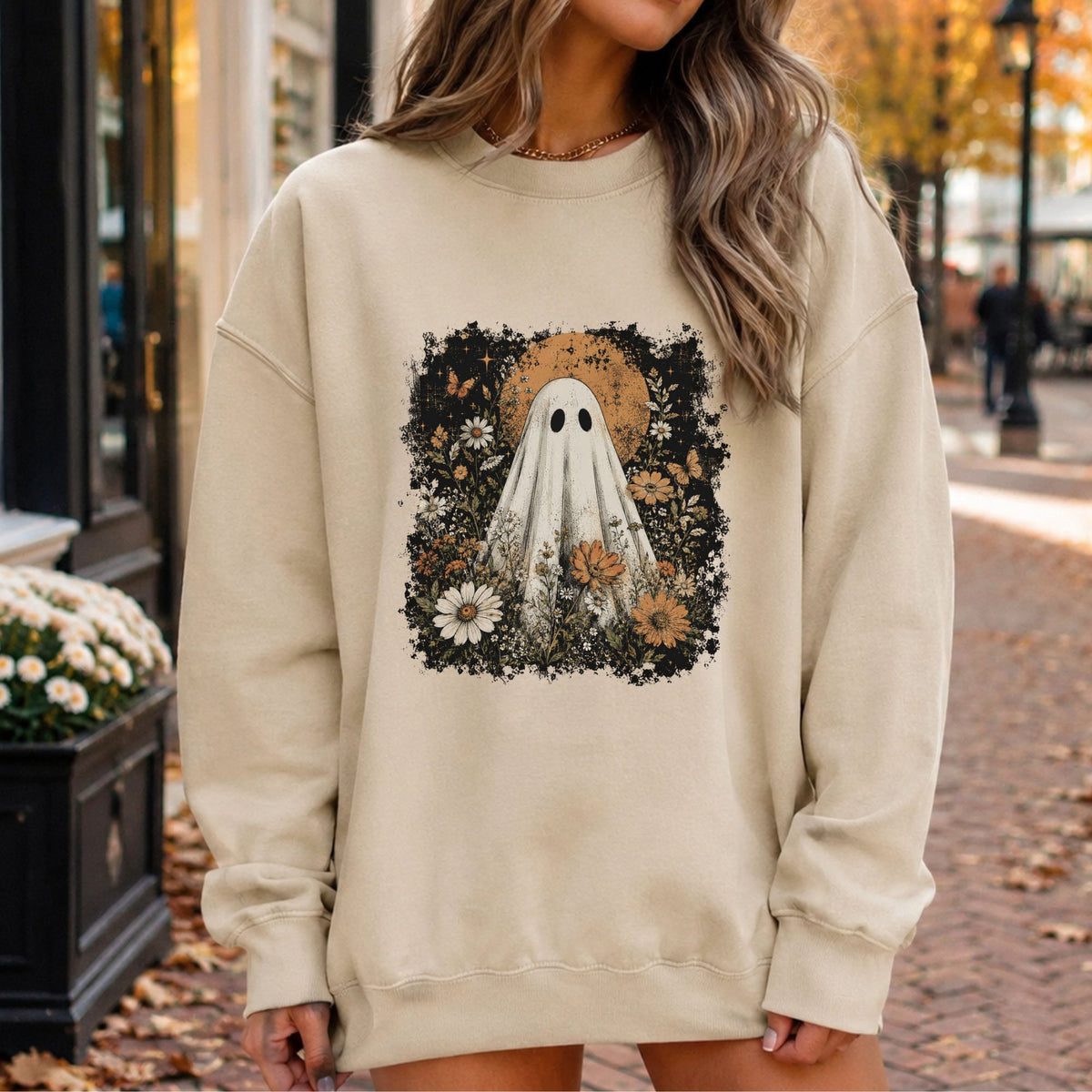 Boho Halloween DTF transfer featuring a vintage-style white ghost surrounded by wildflowers, daisies, orange florals, butterflies, stars, greenery, and a large distressed orange moon.