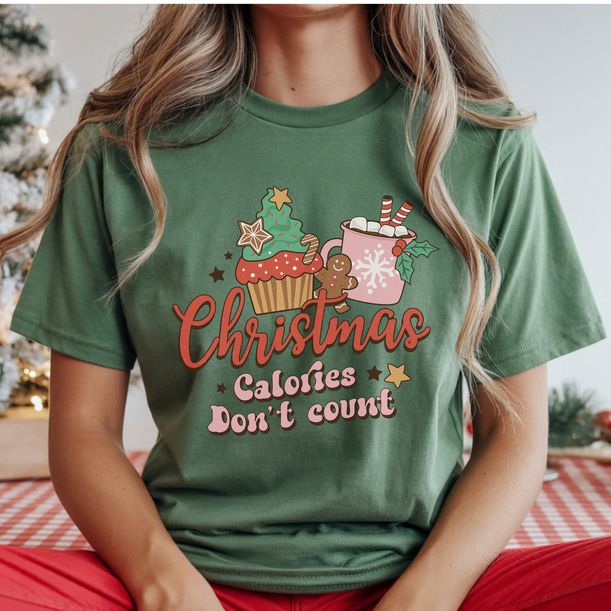 “Christmas Calories Don’t Count” with a Christmas tree cupcake, gingerbread cookie and pink hot cocoa mug, in a distressed retro style.