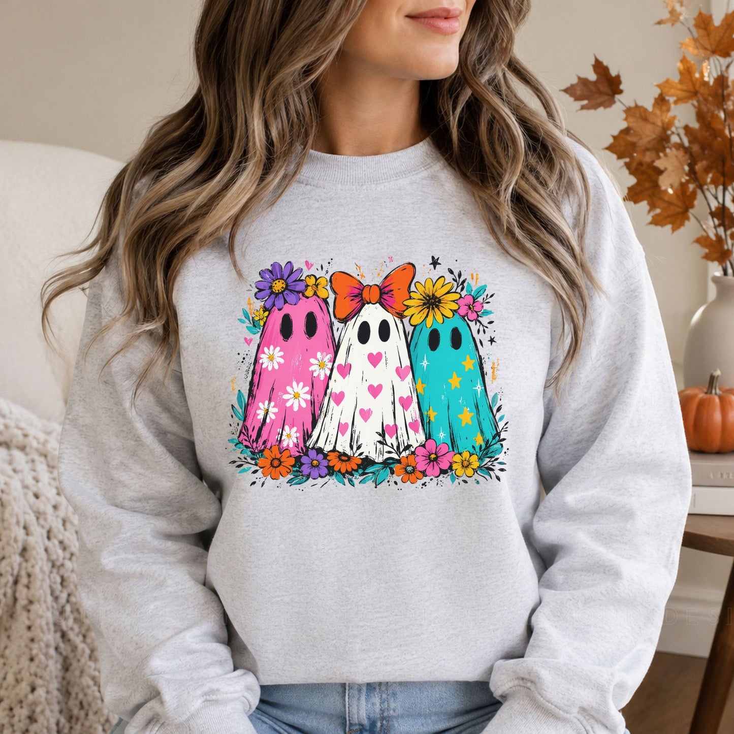 Colorful floral ghost trio Halloween DTF transfer featuring pink, white and teal ghosts decorated with hearts, stars, daisies, flowers and a bright orange bow on a gray sweatshirt mockup.
