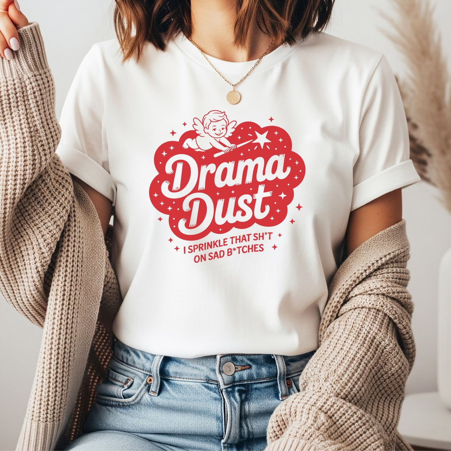 Funny retro drama dust design featuring a cupid sprinkling drama dust with the sarcastic phrase I sprinkle that sh*t on sad b*tches, humorous graphic for women who love witty humor and bold statement tees