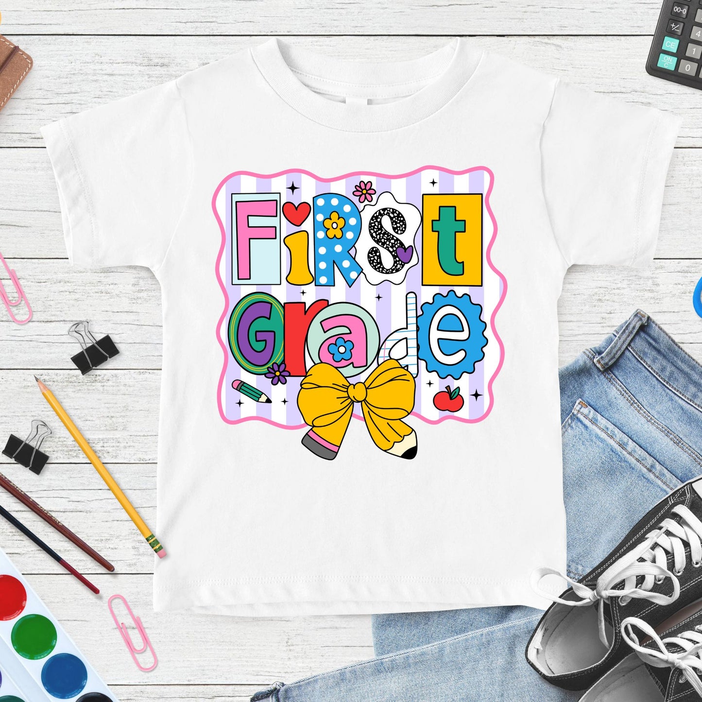 Colorful First Grade back-to-school design featuring playful patterned letters, a large yellow pencil bow, apple, flowers, pencil accents, and pastel striped classroom graphics.