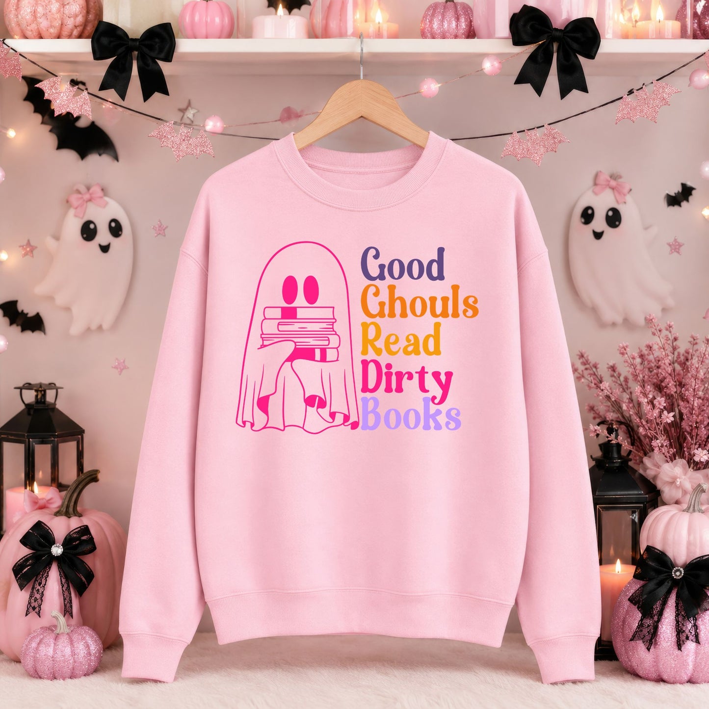 Good Ghouls Read Dirty Books Halloween DTF transfer featuring a bright pink ghost holding a stack of books with colorful retro typography, displayed on a pink sweatshirt mockup.