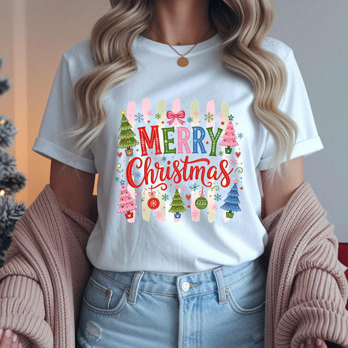 Merry Christmas DTF transfer with multicolored lettering, pink, green and blue trees, ornaments, snowflakes and a bow over vertical pink and sage brushstroke stripes.