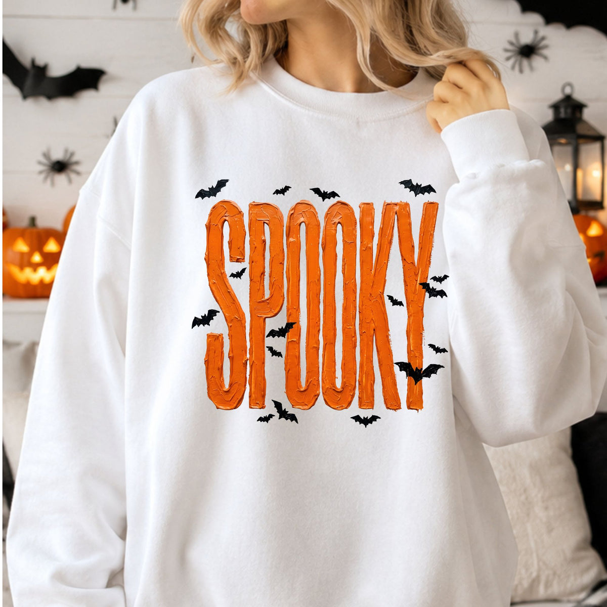 Painted brushstroke Halloween DTF transfer featuring the word SPOOKY in bold textured orange lettering surrounded by flying black bats on a transparent background.