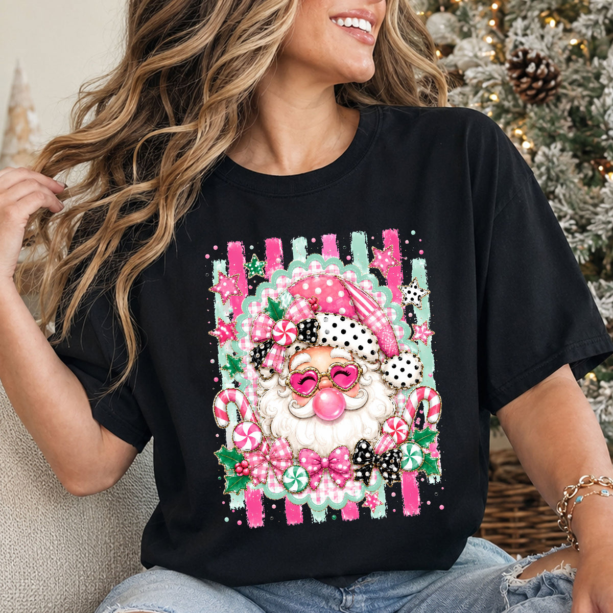 Santa blowing pink bubblegum in heart sunglasses and a pink hat with black polka dot trim, surrounded by bows, peppermint candy and pink and mint brushstrokes.