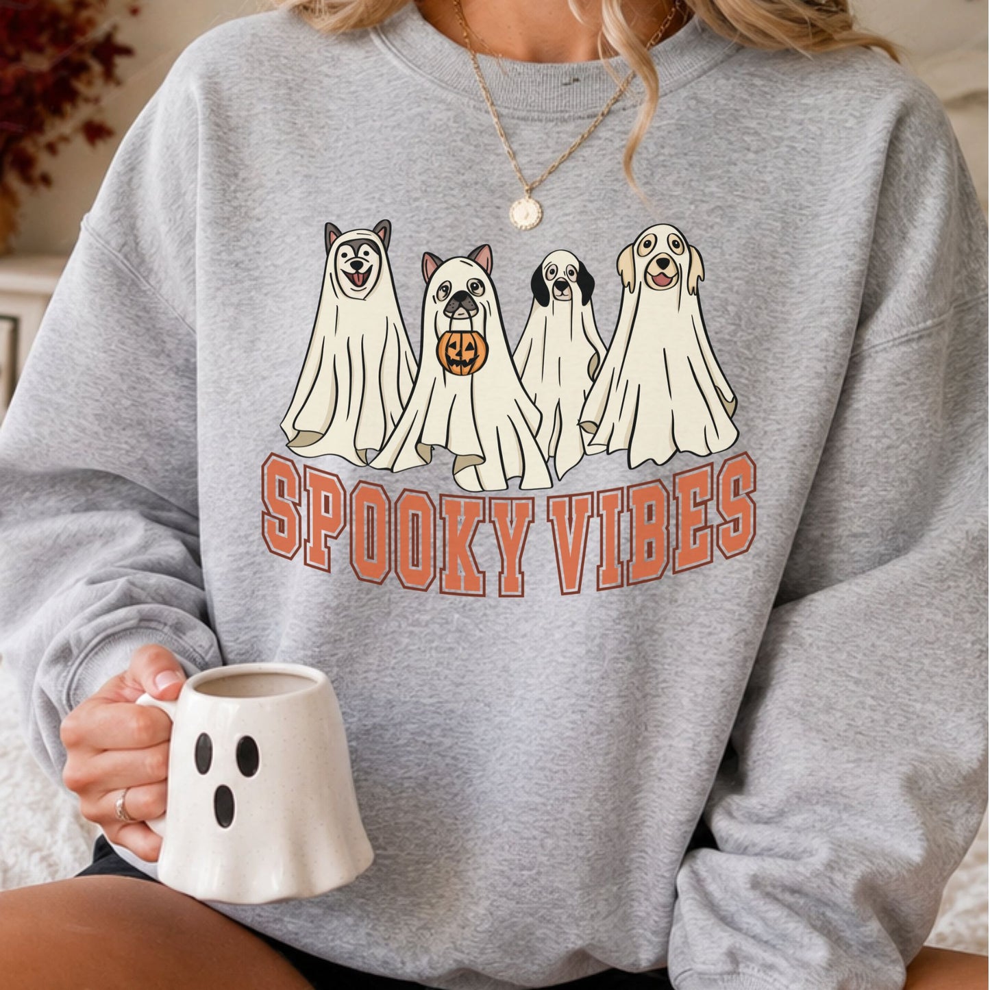 Spooky Vibes Halloween DTF transfer featuring four adorable dogs wearing white ghost costumes, including one holding a jack-o-lantern candy bucket, displayed on a gray sweatshirt mockup.