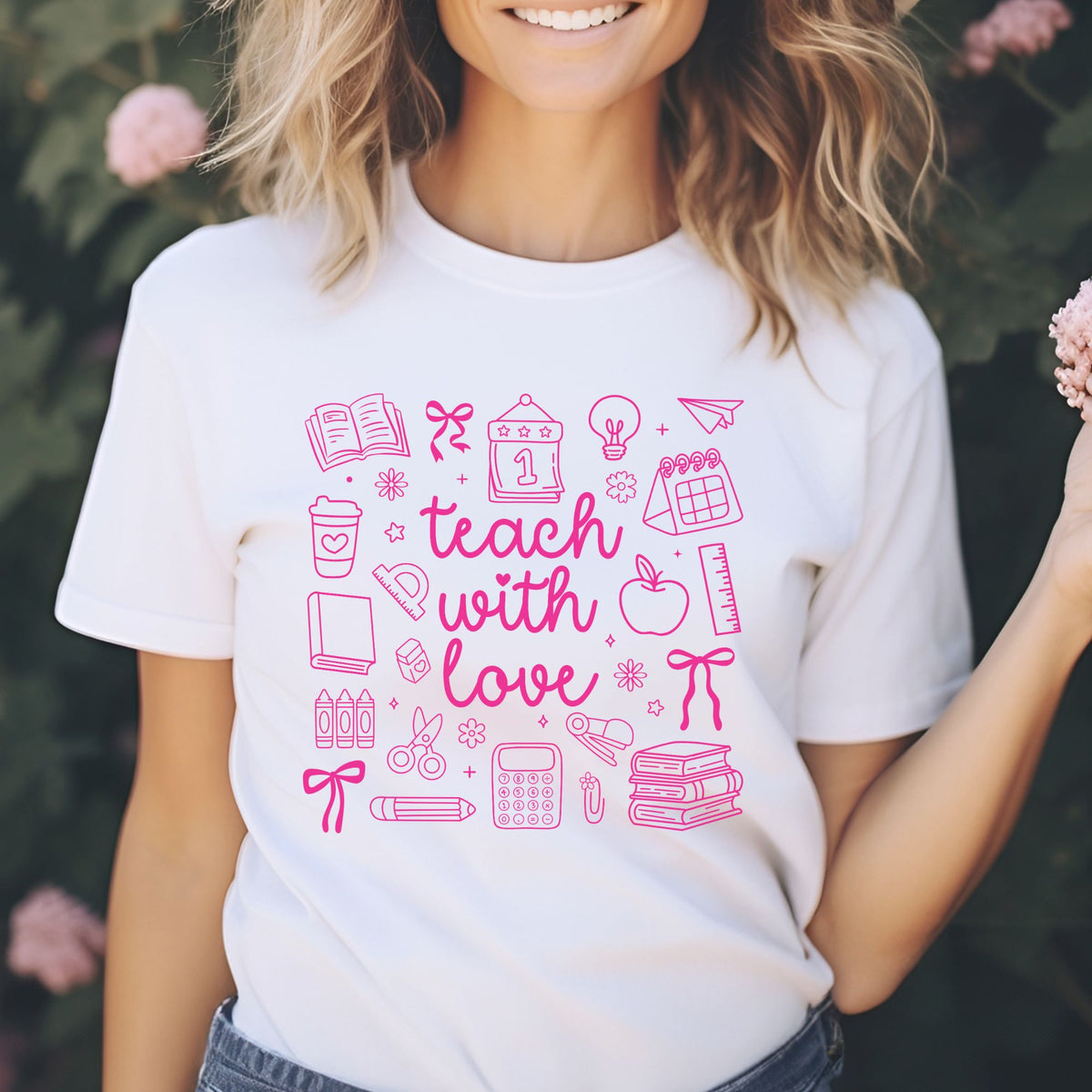 Teach With Love DTF transfer featuring bright pink script lettering surrounded by school doodles, books, bows, apple, ruler, crayons, calculator, and classroom supplies.