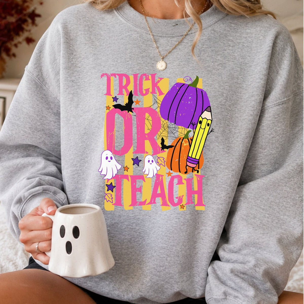 Trick or Teach Halloween teacher DTF transfer featuring bright pink and yellow lettering, purple and orange pumpkins, ghosts, bats, spiderweb and pencil