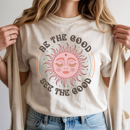 Boho celestial sun design featuring a vintage pink sun face with rainbow accents and the inspirational quote Be The Good See The Good