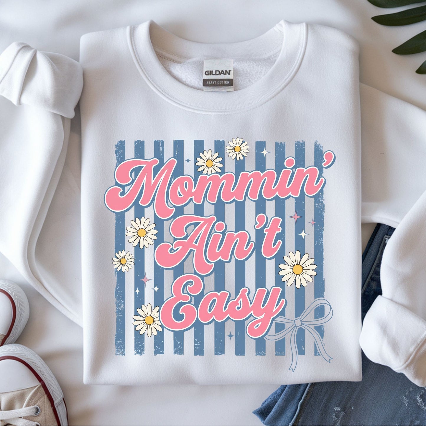Coquette mommin ain't easy DTF transfer with pink retro lettering, blue stripes, daisies, and bow accents