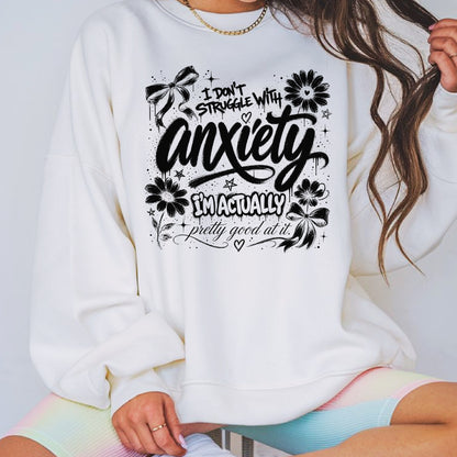 Black and white anxiety humor graphic featuring floral doodles, bows, stars, and the phrase I Don't Struggle With Anxiety I'm Actually Pretty Good At It in a trendy hand-lettered design