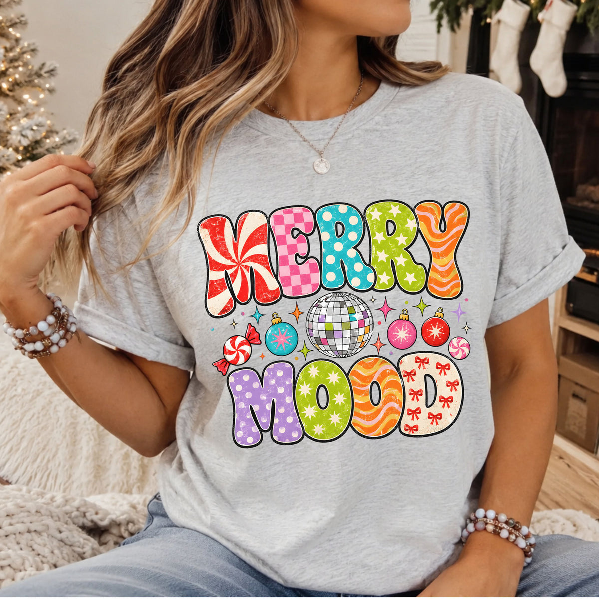 Merry Mood in colorful distressed bubble letters with peppermint swirls, pink checks, polka dots, stars and red bows, surrounding a silver disco ball, Christmas ornaments and candy.