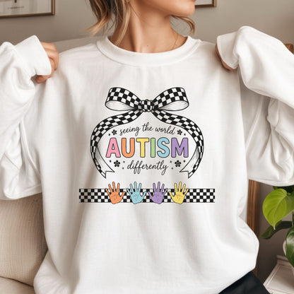 seeing the world differently autism dtf transfer rainbow lettering checkered bow design colorful handprints autism awareness tee or hoodie