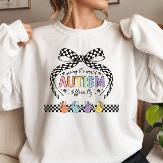 seeing the world differently autism dtf transfer rainbow lettering checkered bow design colorful handprints autism awareness tee or hoodie