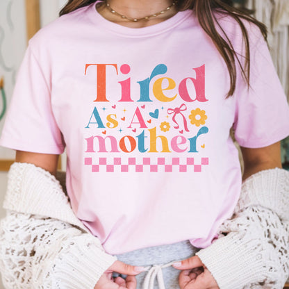 Tired as a mother DTF transfer with colorful retro lettering, hearts, flowers, bow, and pink checkerboard accents