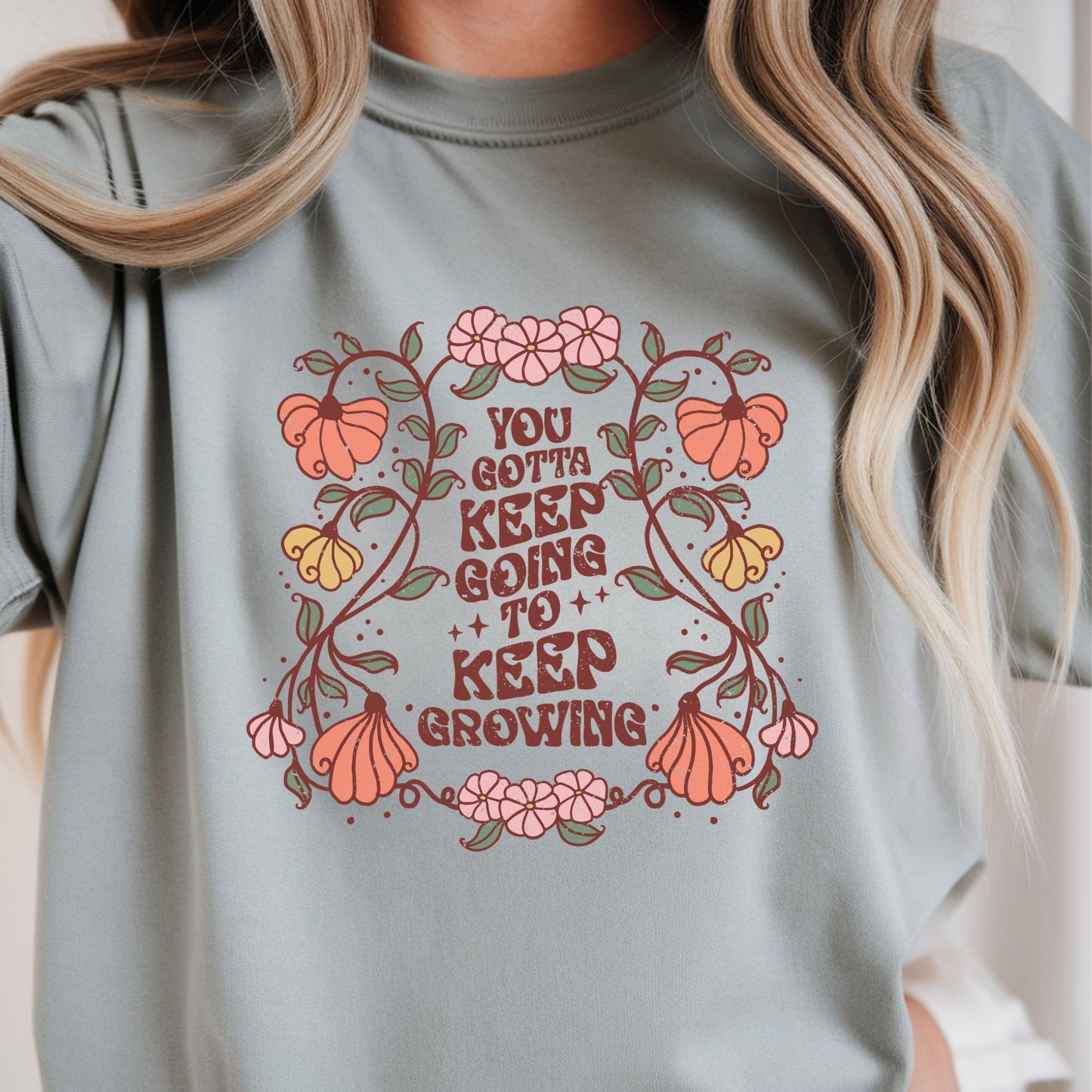 Retro boho floral graphic with the quote You Gotta Keep Going To Keep Growing surrounded by whimsical flowers and vines