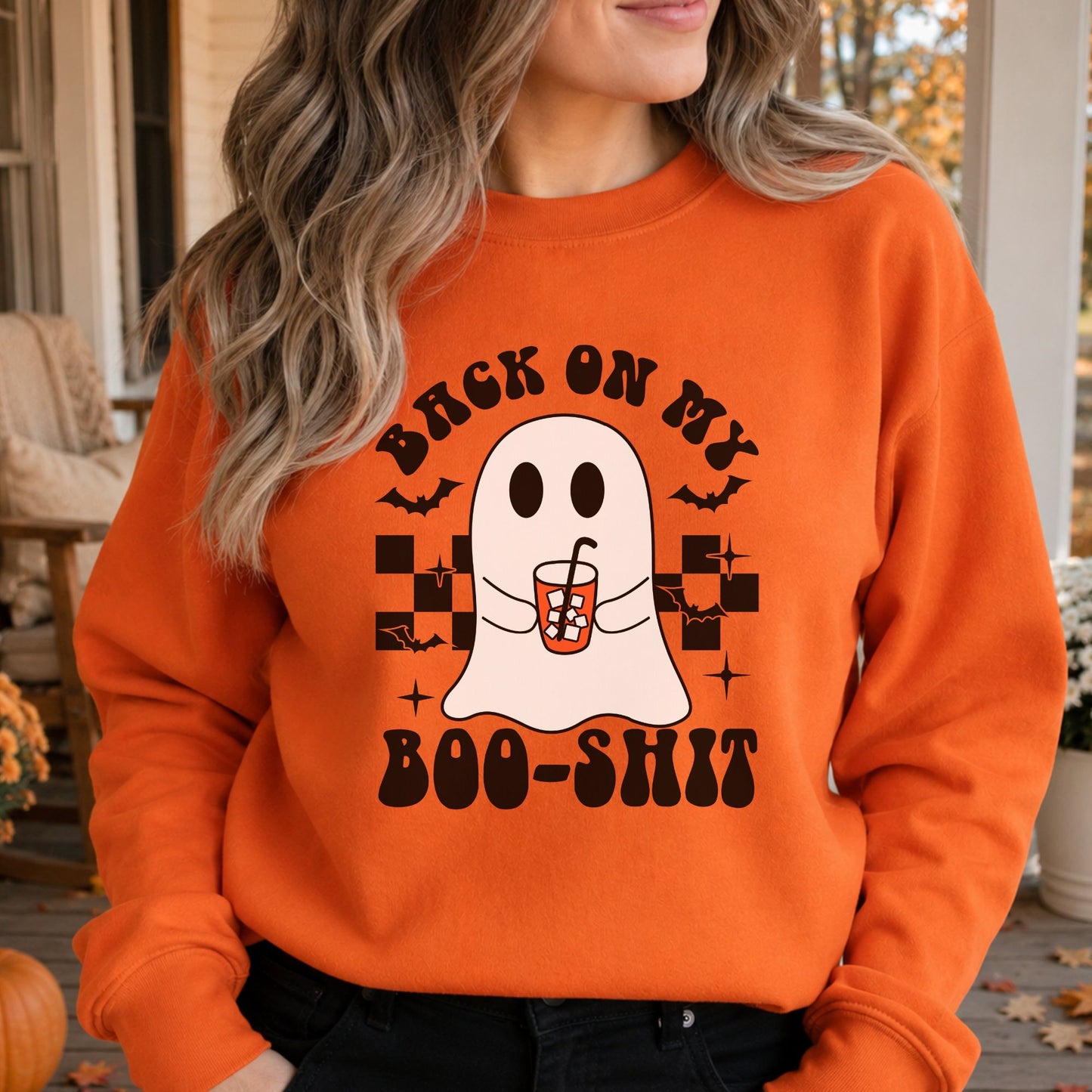 Orange crewneck mockup featuring the Back on My Boo-Shit ghost holding an iced coffee Halloween DTF transfer design.