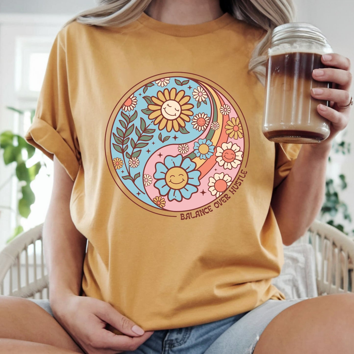 Retro boho yin yang floral design featuring smiling flowers and the phrase "Balance Over Hustle." Perfect for mindfulness, self-care, wellness, mental health, hippie, and bohemian aesthetic graphic tees and hoodies.
