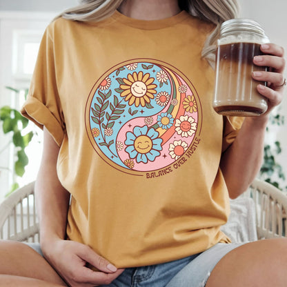 Retro boho yin yang floral design featuring smiling flowers and the phrase "Balance Over Hustle." Perfect for mindfulness, self-care, wellness, mental health, hippie, and bohemian aesthetic graphic tees and hoodies.
