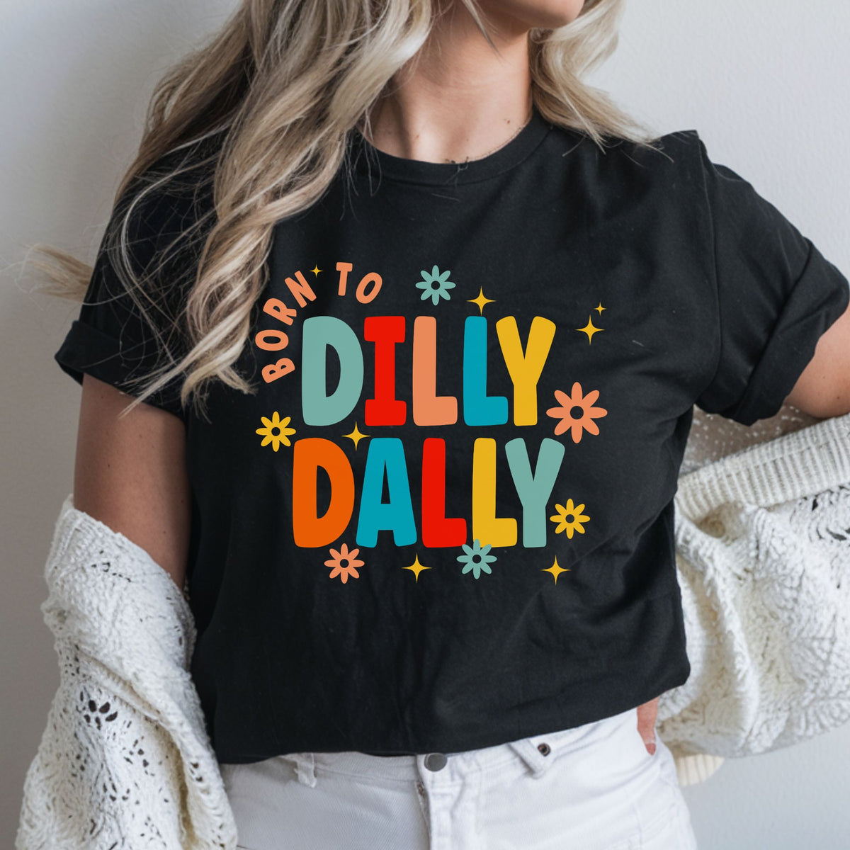 Born to Dilly Dally DTF transfer featuring bold colorful retro lettering with playful flowers, sparkles, and groovy 70s-inspired colors for funny shirts, sweatshirts, tote bags, and casual graphic apparel.