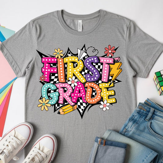 Colorful First Grade back-to-school design featuring bright bubble letters, black-and-white checkerboard accents, flowers, a pencil, paper airplane, lightning bolt, and playful school graphics.