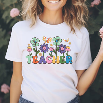 Colorful floral Teacher design featuring smiling retro flowers, butterflies, multicolor lettering, and bold black outlines.