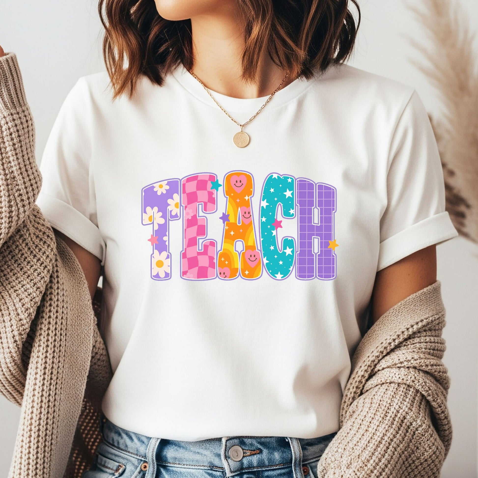Colorful TEACH design featuring oversized patterned letters with daisies, pink checkerboard, smiling retro faces, teal stars, purple grid details, and playful classroom style.