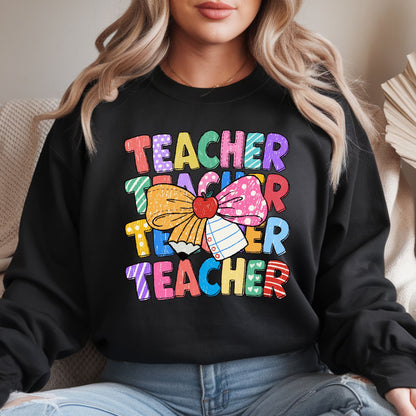 Colorful teacher design featuring stacked patterned Teacher lettering with a large school bow made from a pencil and notebook paper, a red apple center, and bright classroom-inspired colors.