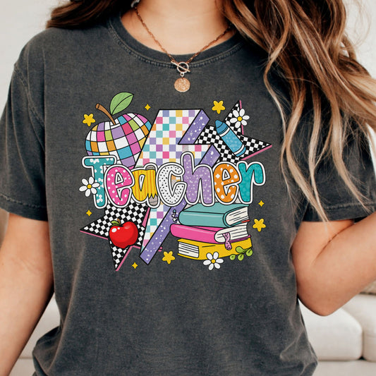 Colorful Teacher design featuring patterned lettering, a bold lightning bolt, checkerboard stars, patchwork apple, crayon, stacked books, daisies, and bright retro classroom accents.