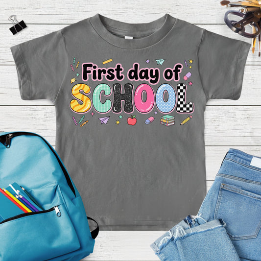 Coquette first day of school design featuring colorful patterned letters with school supplies, books, apple, paper airplane, crayons, and retro classroom icons.
