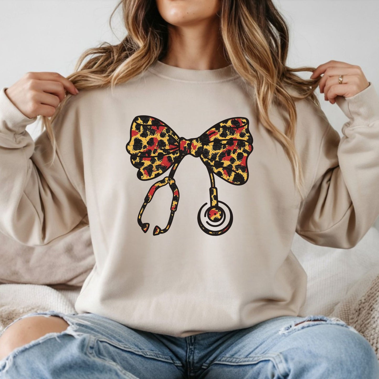 Coquette nurse leopard bow DTF transfer design on beige sweatshirt with stethoscope bow graphic