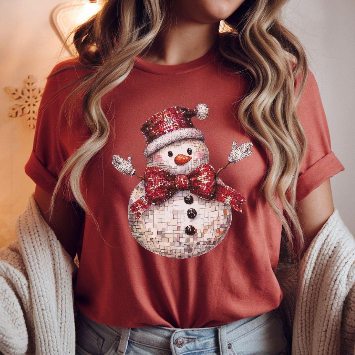 Disco snowman with a silver mosaic tile look, red Santa hat and oversized red bow, orange carrot nose, black buttons and raised white mittens.