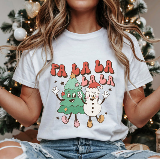 “Fa La La La La” in red and pink bubble letters above a smiling Christmas tree and snowman in a Santa hat, with waving hands, a peace sign and stars.