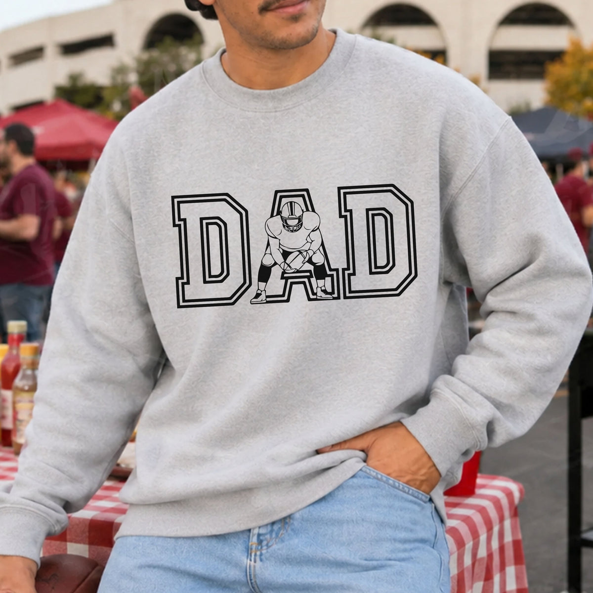 Football Dad DTF transfer featuring bold varsity-style DAD lettering with a football player holding a football incorporated into the center letter.