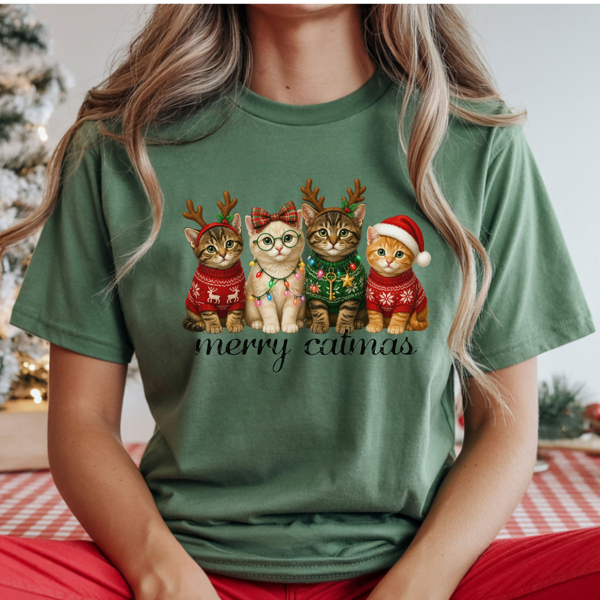 Four Christmas kittens with red and green sweaters, reindeer antlers, a Santa hat and colorful lights, including a cream kitten wearing glasses and a plaid bow.