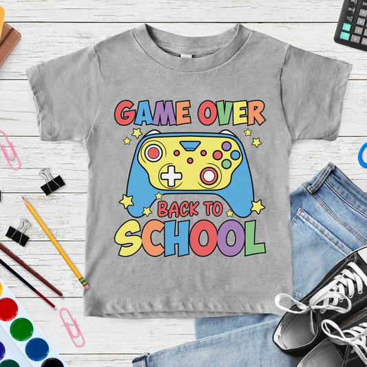 Game Over Back to School design featuring a colorful video game controller, stars, and bold retro lettering for gamer-themed toddler, kids, and youth shirts.