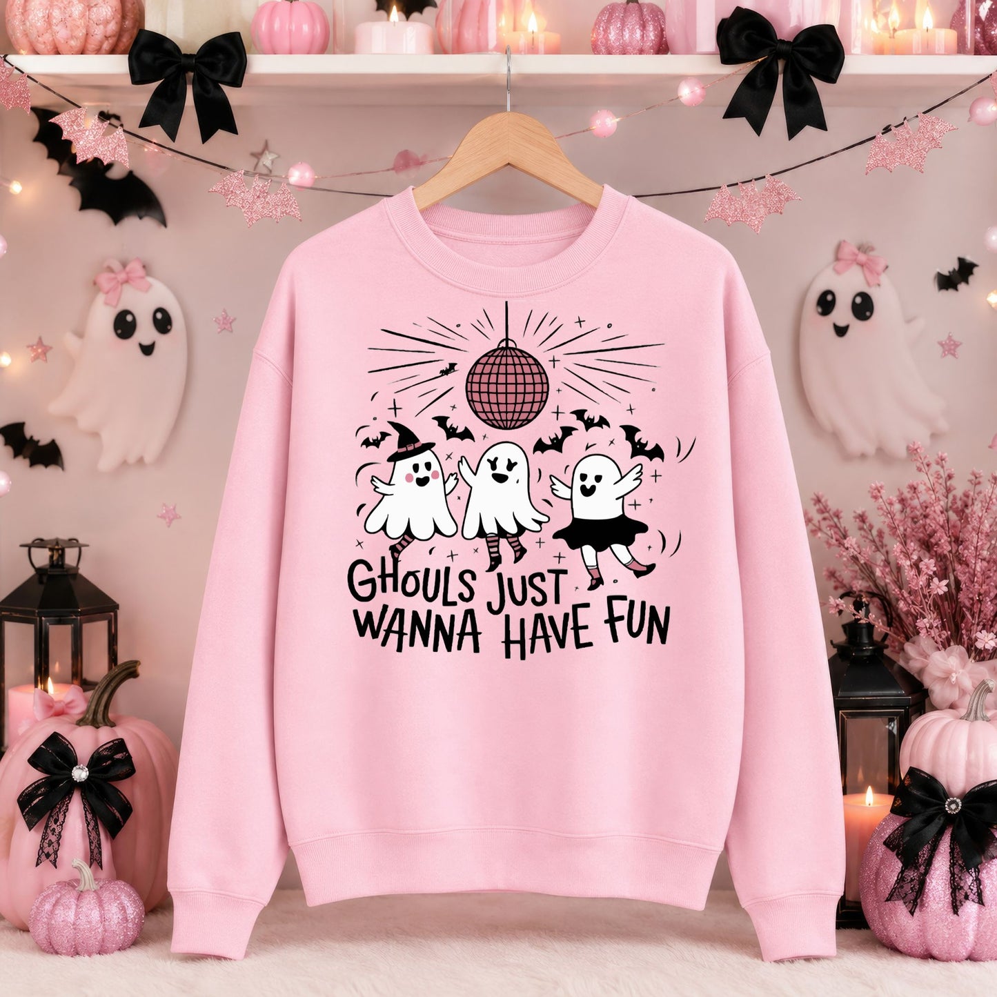Ghouls Just Wanna Have Fun Halloween DTF transfer featuring three dancing ghosts in playful costumes beneath a disco ball, surrounded by bats and sparkling accents on a pink sweatshirt mockup.
