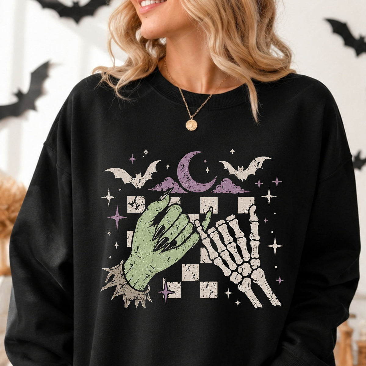 Halloween DTF transfer featuring a green witch hand with black nails reaching toward a white skeleton hand over a distressed purple checkered background with bats, stars, lightning bolts, and celestial spooky details.