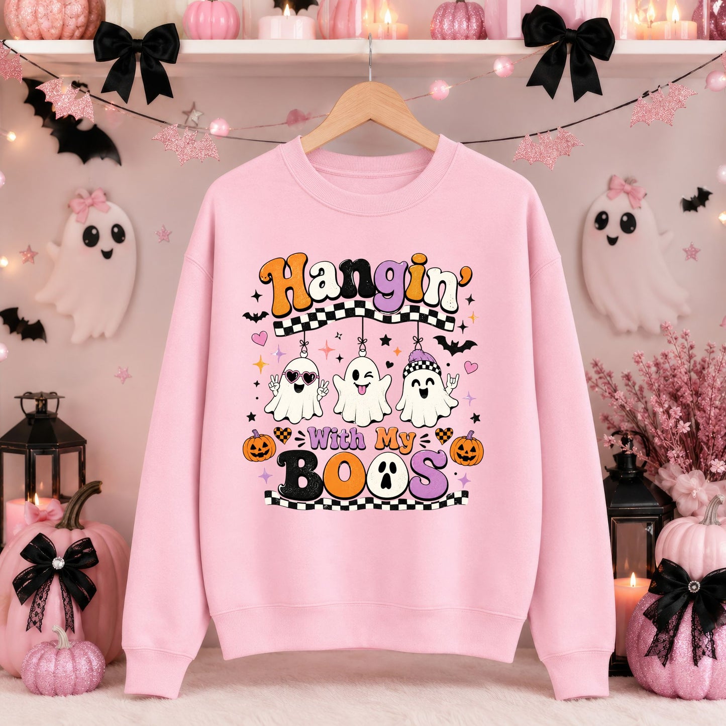 Colorful Hangin’ with My Boos Halloween DTF transfer featuring three playful ghosts wearing heart sunglasses, a purple beanie and spooky accessories, surrounded by bats, pumpkins, hearts, stars and black-and-white checkerboard accents on a pink sweatshirt mockup.