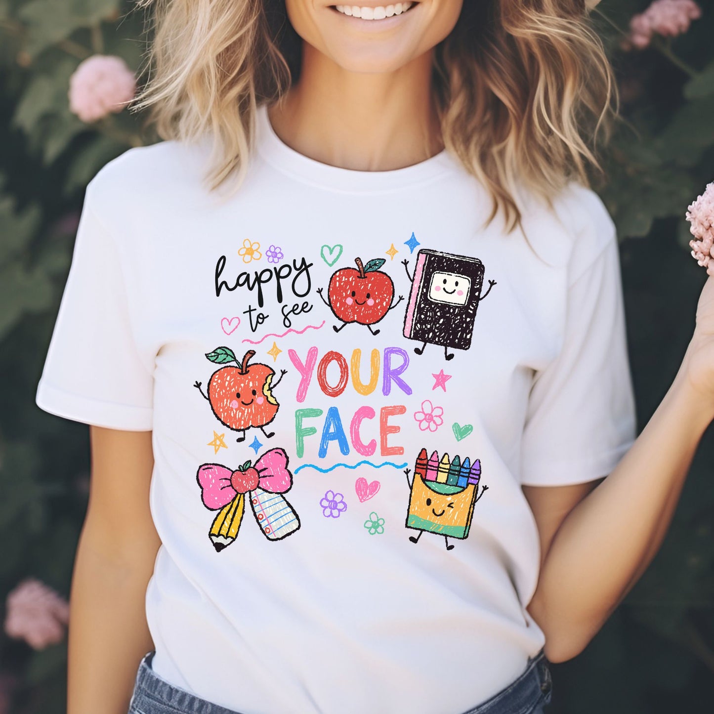 Happy to See Your Face school design featuring colorful crayon-style lettering, smiling apples, a happy notebook, pencil and paper bow, crayon box, flowers, hearts, stars, and playful classroom doodles.