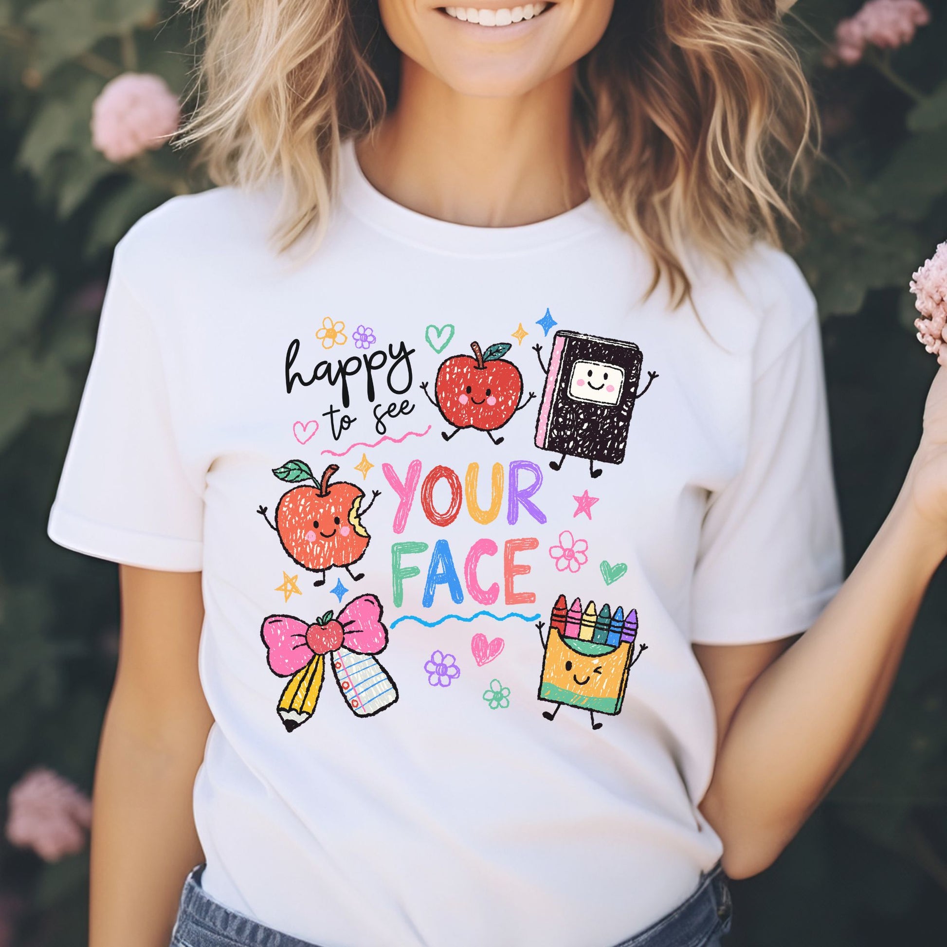 Happy to See Your Face school design featuring colorful crayon-style lettering, smiling apples, a happy notebook, pencil and paper bow, crayon box, flowers, hearts, stars, and playful classroom doodles.