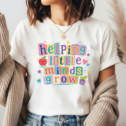 Helping Little Minds Grow teacher design featuring bright colorful block lettering, a smiling apple, hearts, stars, and a small potted plant in a cheerful classroom style.