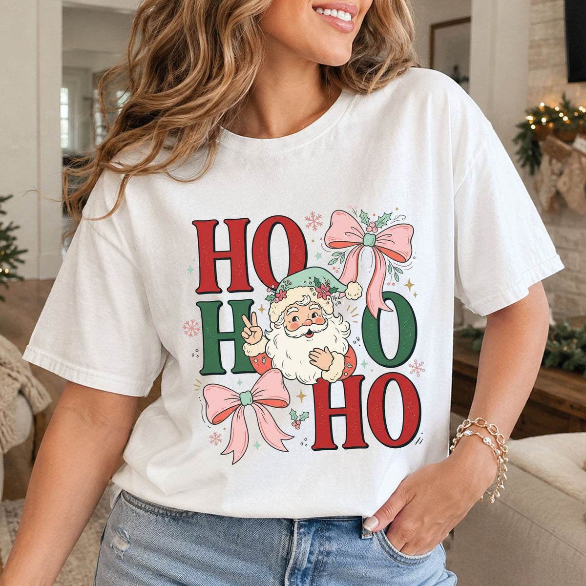 “Ho Ho Ho” in red and green letters with Santa making a peace sign and wearing a mint floral hat, surrounded by pink bows, holly, pink snowflakes and gold stars.