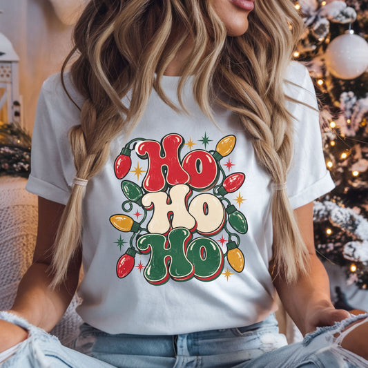 Ho Ho Ho Christmas DTF transfer with stacked red, cream and dark green retro lettering, colorful string lights, starbursts and a distressed vintage style.