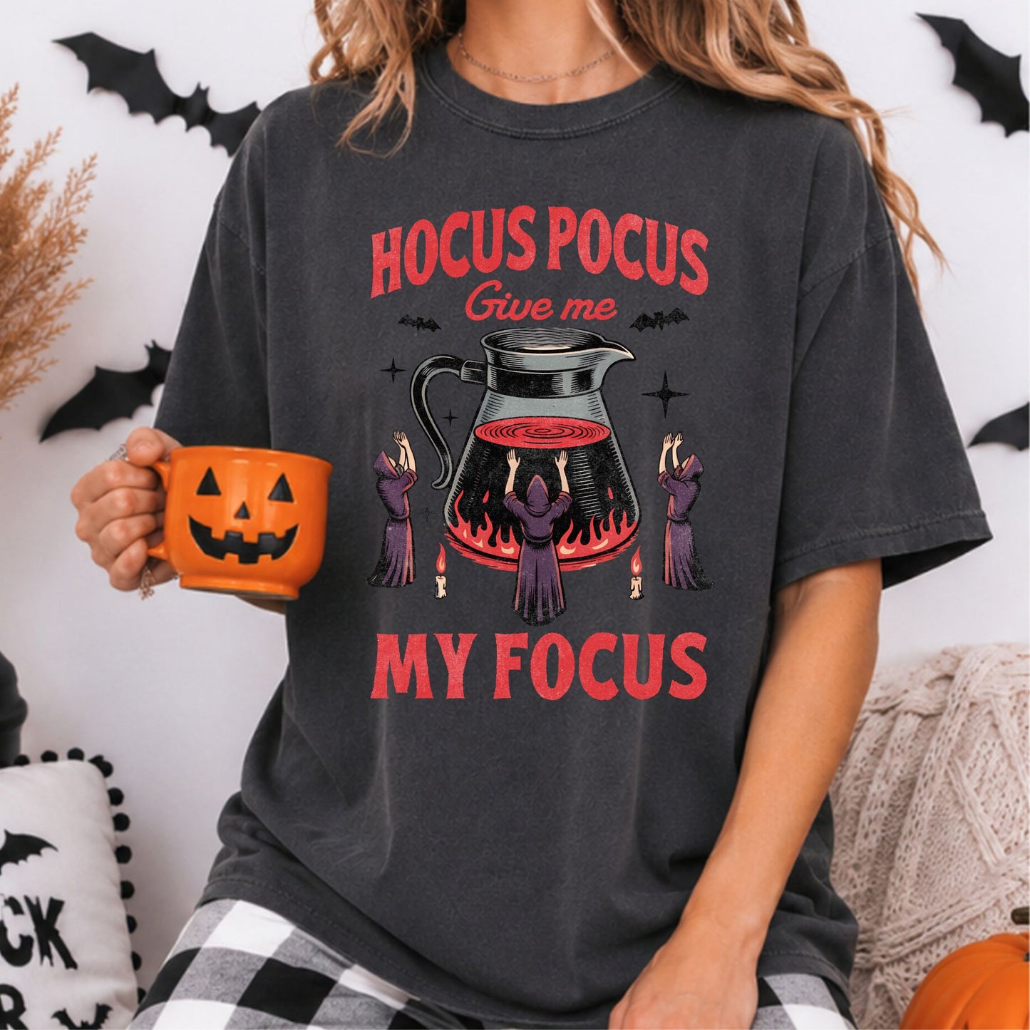 Hocus Pocus Give Me My Focus Halloween DTF transfer featuring three purple-robed witches gathered around a giant coffee pitcher with red flames, candles, bats and sparkling accents on a dark gray T-shirt mockup.