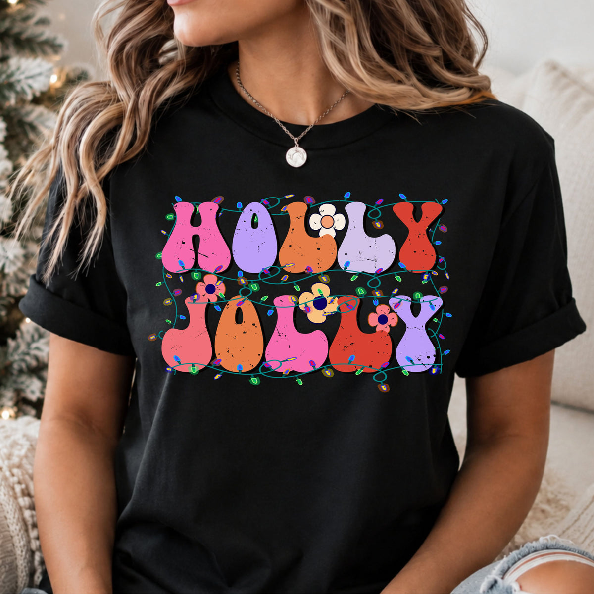 Holly Jolly in distressed pink, purple, orange and red bubble letters, decorated with retro flowers and tangled multicolored Christmas lights on teal cords.