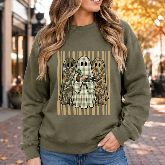 Halloween DTF transfer featuring a trio of hunting-inspired ghosts in woodland camo, green checkered, and nature print patterns with a mallard duck, bow detail, and rustic outdoorsy colors.